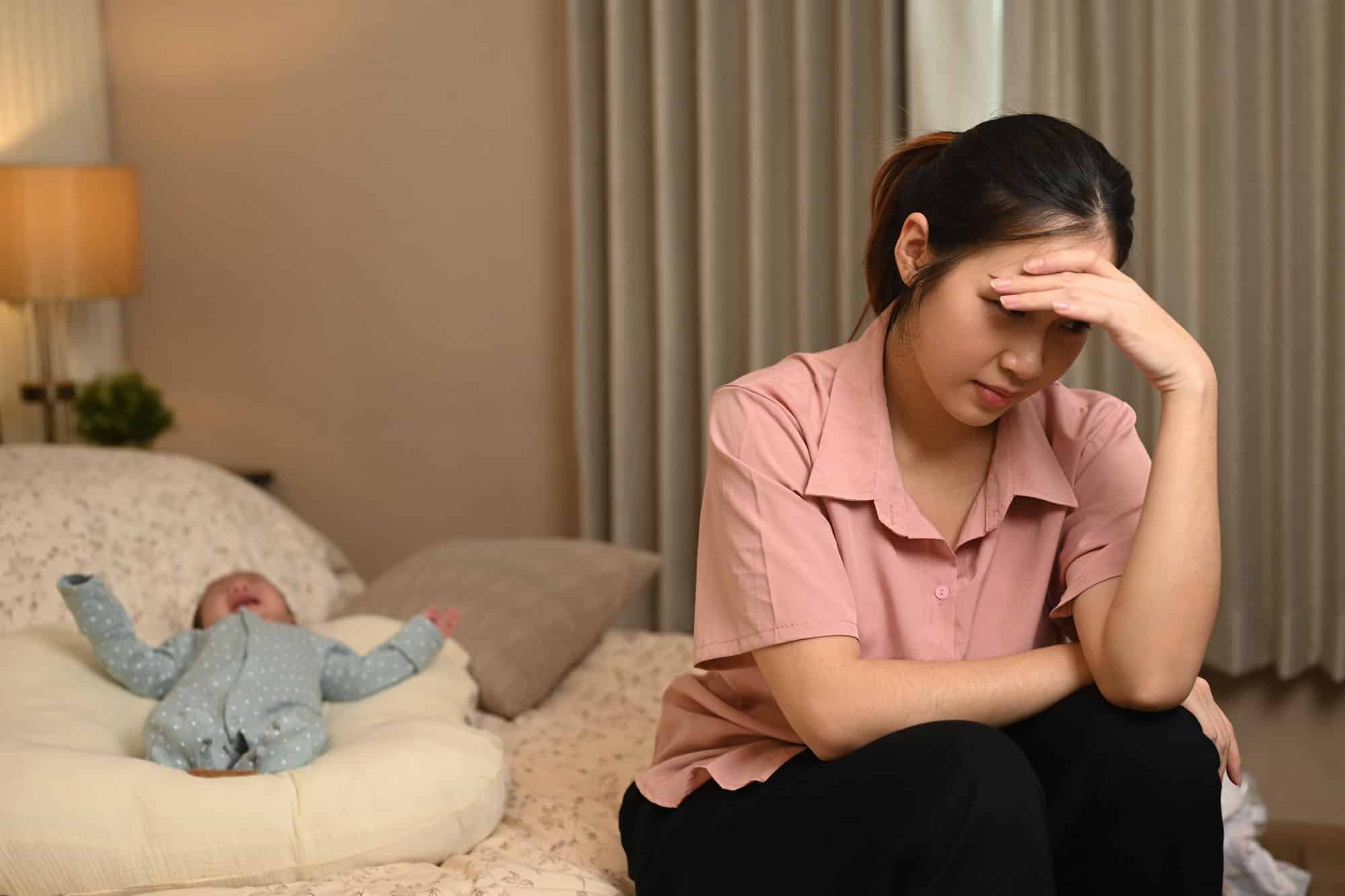 Exhausted young mother suffering from postnatal depression